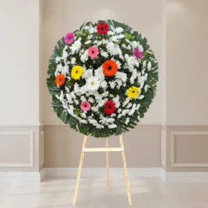 Corona floral con gerberas de colores para luto y condolencias
