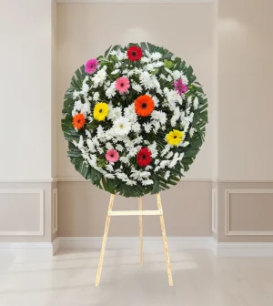 Corona floral con gerberas de colores para luto y condolencias
