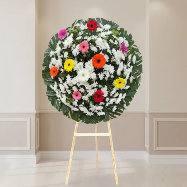 Corona floral con gerberas de colores para luto y condolencias